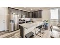 Modern kitchen with stainless steel appliances, granite countertops, and stylish cabinets at 8833 Meade St, Westminster, CO 80031