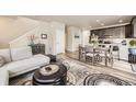 Open-concept living room and dining area featuring modern decor and hardwood floors at 8833 Meade St, Westminster, CO 80031