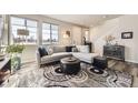 Bright and airy living room featuring a large sectional sofa and decorative rug at 8833 Meade St, Westminster, CO 80031