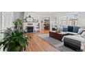 Bright living room with hardwood floors and large windows at 1351 Reed St, Lakewood, CO 80214