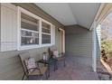 Inviting front porch featuring cozy seating and stylish decor at 1351 Reed St, Lakewood, CO 80214