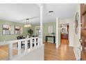 Open dining room with hardwood floors and stylish light fixture next to the kitchen at 3190 Ward Ct, Wheat Ridge, CO 80215