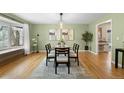 Dining room with hardwood floors, decorative rug and hanging light fixture at 3190 Ward Ct, Wheat Ridge, CO 80215