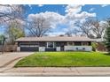 Charming single-story home with a well-maintained front yard and two-car garage at 3190 Ward Ct, Wheat Ridge, CO 80215