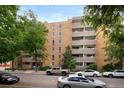 Multi-story brick apartment building featuring multiple balconies and a well-maintained landscaped exterior at 551 N Pearl St # 207, Denver, CO 80203