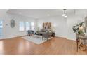 Bright living room features hardwood floors, a modern couch, lots of natural light, and decor at 6102 E Yale Ave, Denver, CO 80222