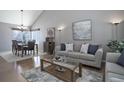 Cozy living room with hardwood floors, a comfortable sofa, and a dining area in an open-concept design at 8915 Edgewood Ln, Highlands Ranch, CO 80130