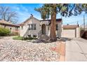 Inviting home with mature trees, showcasing a low-maintenance rock garden and a cozy entryway at 3319 E 27Th Ave, Denver, CO 80205