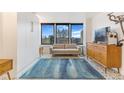 Inviting living room with large windows offering city views and decorative patterned flooring at 789 N Clarkson St # 406, Denver, CO 80218