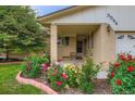 Inviting front porch with colorful flowerbeds at 3544 Dyanna Dr, Thornton, CO 80241