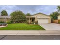 Single-story brick home boasting a lovely lawn and landscaping at 3544 Dyanna Dr, Thornton, CO 80241