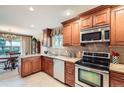 Well-lit kitchen with stainless steel appliances and granite countertops at 3544 Dyanna Dr, Thornton, CO 80241