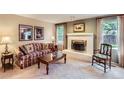 Cozy living room with a brick fireplace and comfortable seating at 3544 Dyanna Dr, Thornton, CO 80241