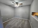 Neutral bedroom featuring carpet, a ceiling fan with light, and grey walls and trim at 14499 E 1St Dr # A05, Aurora, CO 80011