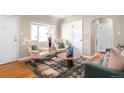 Cozy living room with modern furnishings, lots of light, and hardwood floors at 2686 S Gilpin St, Denver, CO 80210