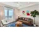 Comfortable living room features a leather sofa, stylish rug, modern art, and ample natural light at 2120 N Downing St # 216, Denver, CO 80205