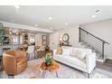 Spacious living room that features an open concept with sleek hardwood flooring, and access to the basement and kitchen at 2226 S Galapago St, Denver, CO 80223