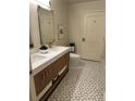 Elegant bathroom featuring double vanity with quartz countertop and modern mosaic tile floor at 1975 N Grant # 310, Denver, CO 80203