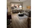 Open floor plan featuring a living room with a gray sofa and a kitchen with breakfast bar seating at 1975 N Grant # 310, Denver, CO 80203