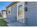 Close-up of the front door entrance featuring stylish details and the house number 2080 at 2080 S King St, Denver, CO 80219