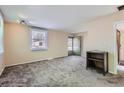 Inviting living room with neutral walls and gray carpeting, creating a cozy and comfortable space at 2080 S King St, Denver, CO 80219