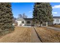 Charming home with mature trees, a well-maintained lawn, and a welcoming walkway at 3460 S Eudora St, Denver, CO 80222