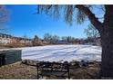 Community frozen pond with a bench and winter trees at 309 E Highline Cir # 103, Centennial, CO 80122