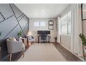 Bright home office with wood floors, gray accent wall, and comfortable seating at 1123 Sunrise Dr, Brighton, CO 80603