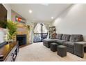 Spacious living room with fireplace and access to a balcony at 10273 E Peakview Ave # D202, Englewood, CO 80111