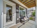 Inviting front porch with a bench and the home's address displayed above a large window at 10379 Vaughn Way, Commerce City, CO 80022