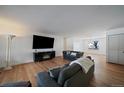 Spacious living room featuring hardwood floors, comfortable seating, and a modern fireplace at 10092 Lee St, Broomfield, CO 80021