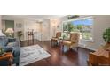 Spacious living room with large windows, hardwood floors, and comfortable armchairs at 19260 Spring Valley Rd, Monument, CO 80132