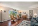 Bright living room with hardwood floors, a piano, and a comfortable seating area at 19260 Spring Valley Rd, Monument, CO 80132