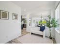 Bright entryway featuring white walls, wood floors, and an open view of the kitchen and dining area at 198 Starlight Cir, Erie, CO 80516