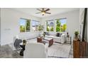 Inviting living room with large windows, neutral decor, and comfortable seating arrangement at 198 Starlight Cir, Erie, CO 80516