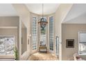 Bright entryway features tall windows, modern light fixture, and neutral decor for an inviting ambiance at 846 Circle K Ranch Rd, Evergreen, CO 80439