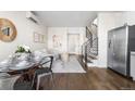 Cozy living room with hardwood floors, staircase, modern furniture and a round dining table at 1305 Osceola St, Denver, CO 80204