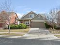 Charming two-story home with a driveway and a manicured front lawn at 11060 River Oaks Ln, Commerce City, CO 80640