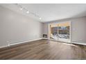 Bright living room boasts modern flooring and sliding doors leading to a balcony at 765 S Alton Way # 6B, Denver, CO 80247