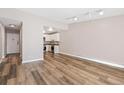 Open-concept living area featuring wood floors and an entrance to the kitchen at 765 S Alton Way # 6B, Denver, CO 80247