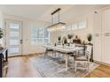 Bright dining room featuring modern lighting, elegant decor and natural light streaming through shuttered windows at 4170 Vrain St, Denver, CO 80212