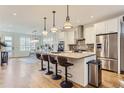 Open concept kitchen with a large center island, stylish pendant lighting and stainless steel appliances at 4170 Vrain St, Denver, CO 80212