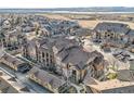 Aerial view showcasing the community layout and nearby lake at 10056 W Unser Dr # 204, Littleton, CO 80127