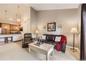 Inviting living room featuring a comfortable leather sofa and chair, with an open layout to the kitchen at 10056 W Unser Dr # 204, Littleton, CO 80127