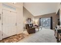 Inviting living room with neutral tones, high ceilings, and natural light at 10056 W Unser Dr # 204, Littleton, CO 80127