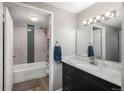 Stylish bathroom with a marble countertop vanity, sleek fixtures, and a tiled shower-tub with decorative inlays at 800 N Pearl St # 1211, Denver, CO 80203