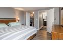 Inviting bedroom boasts hardwood floors, a spacious closet with organized storage, and an adjacent bathroom at 800 N Pearl St # 1211, Denver, CO 80203