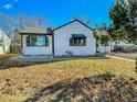 White house with black accents and a well-maintained lawn at 886 Kenton St, Aurora, CO 80010