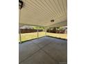 Covered patio with concrete flooring, offering a comfortable outdoor space overlooking the backyard at 2513 S Crystal St, Aurora, CO 80014