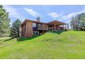 Spacious backyard with covered patio and deck provides ample space for outdoor enjoyment at 6155 Meadowbrook Dr, Morrison, CO 80465